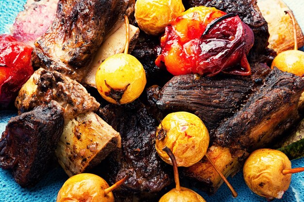 Delicious beef ribs roasted in plums and pears.Meat ribs in fruit