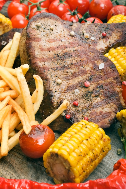 Delicious beef steaks on wooden table