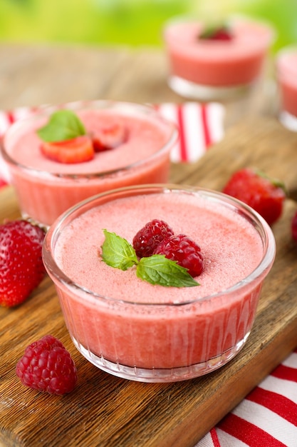 Delicious berry mousse in bowls on table closeup