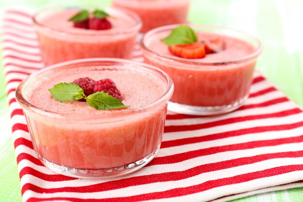 Delicious berry mousse in bowls on table closeup