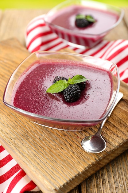 Delicious berry mousse in bowls on table closeup