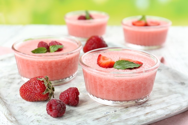 Delicious berry mousse in bowls on table closeup