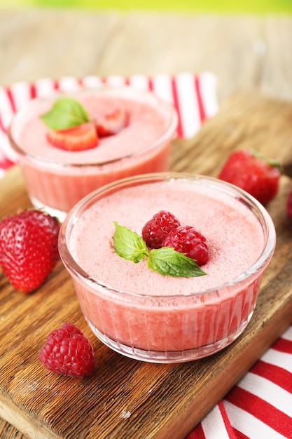 Delicious berry mousse in bowls on table closeup