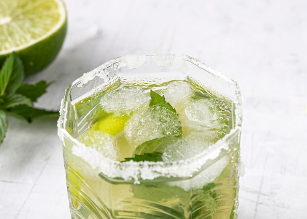 Delicious beverage with lime and ice high angle