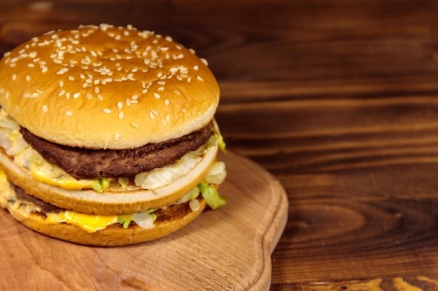 Delicious big hamburger on wooden table