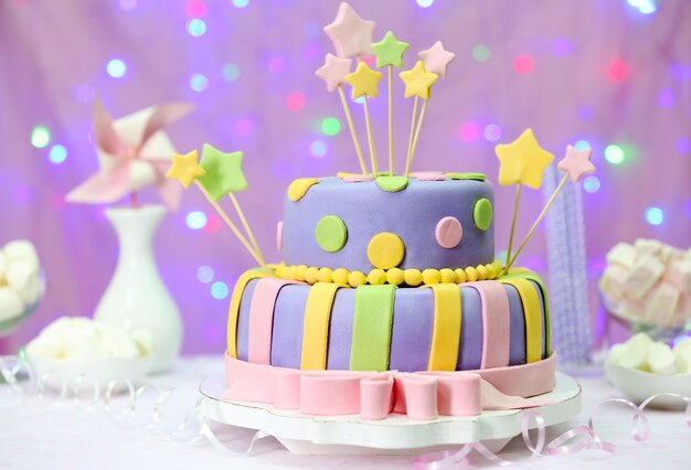 Delicious birthday cake on shiny pink background