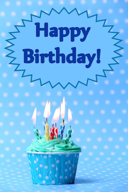 Premium Photo | Delicious birthday cupcake on blue background