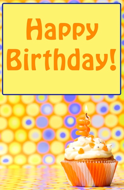 Delicious birthday cupcake on bright background