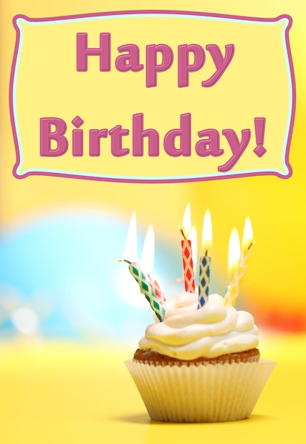 Delicious birthday cupcake on table on bright background