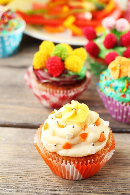 Delicious birthday cupcakes on table closeup