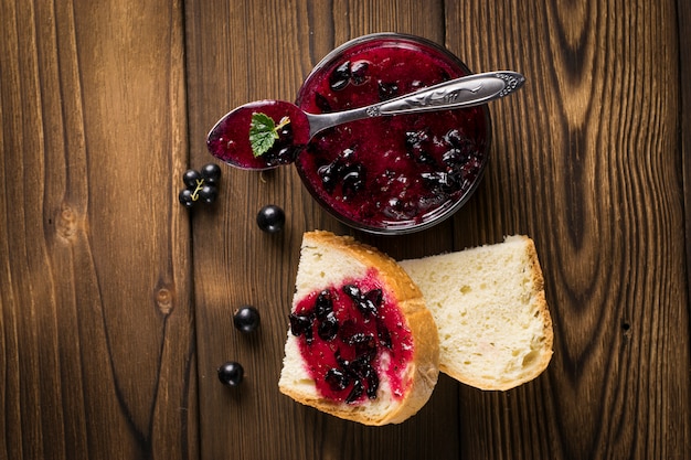 Delicious black currant jam on table close-up