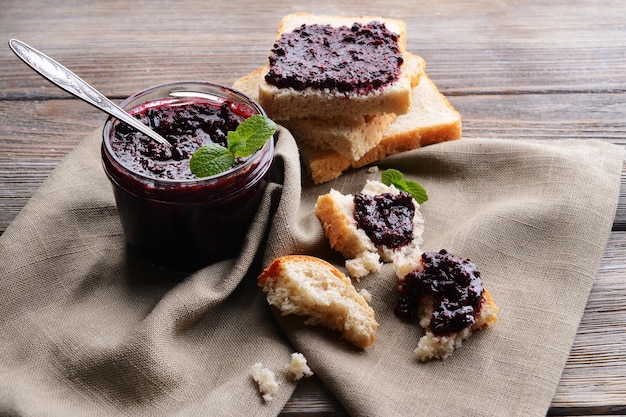 Delicious black currant jam on table closeup