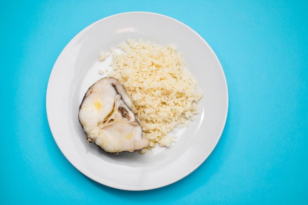 Delicious boiled fish with boiled rice on plate