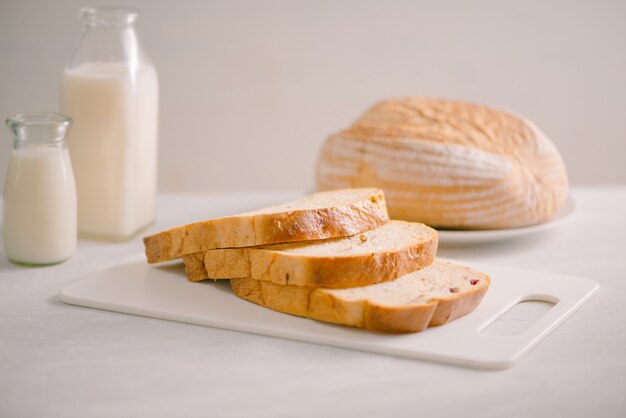 Delicious bread on cutting board on table