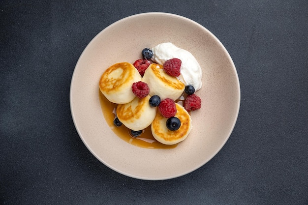 Delicious breakfast cheesecakes with raspberries and blueberries Closeup