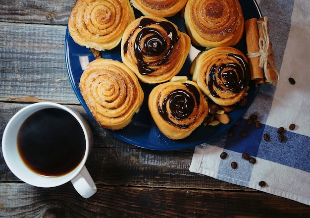 Delicious breakfast, chocolate covered cinnamon roll and a cup of coffee