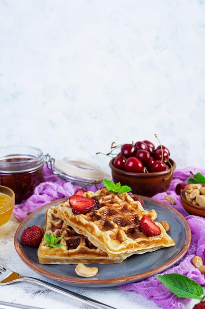 Delicious breakfast with belgian waffles Waffels with strawberry and berry jam