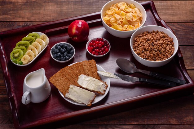 Delicious breakfast with fresh croissants and ripe berries on a beautiful wooden table