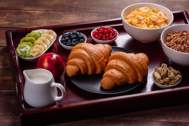 Delicious breakfast with fresh croissants and ripe berries