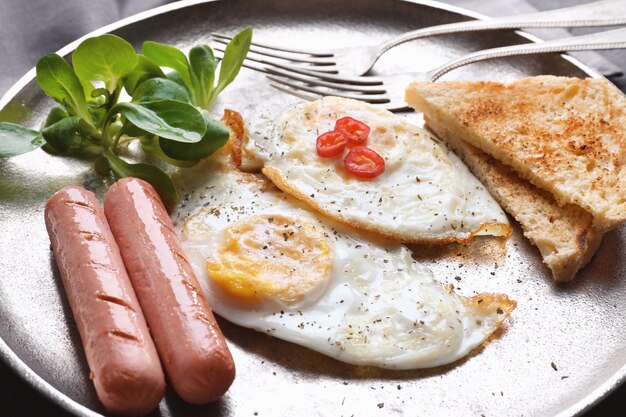 Delicious breakfast with over hard eggs closeup