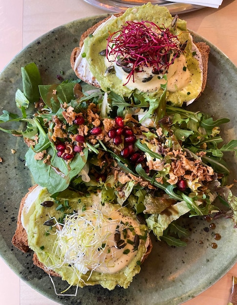 Delicious brunch dish Toast with cream cheese poached eggs and salad