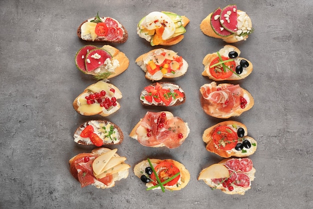 Delicious bruschettas on grey, top view