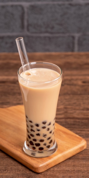 Delicious bubble milk tea with a straw in a glass