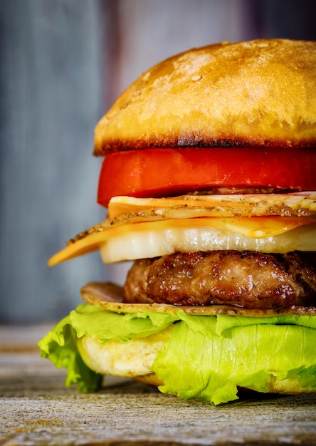 A delicious burger with cheese, lettuce