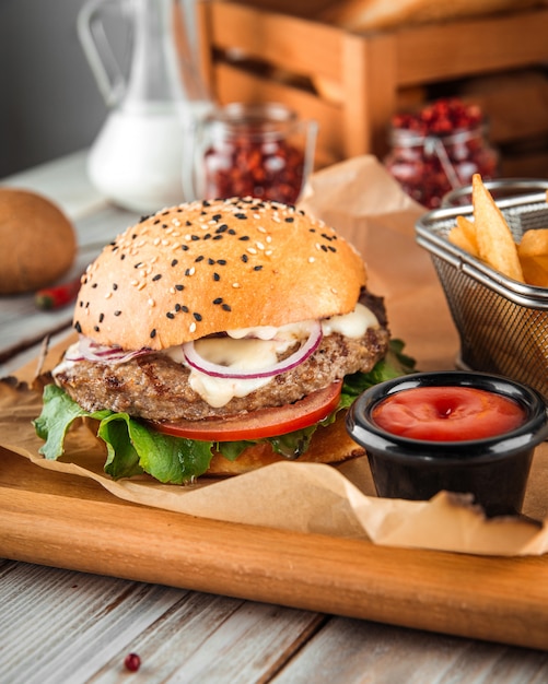 Delicious burger with lamb cutlet and vegetables