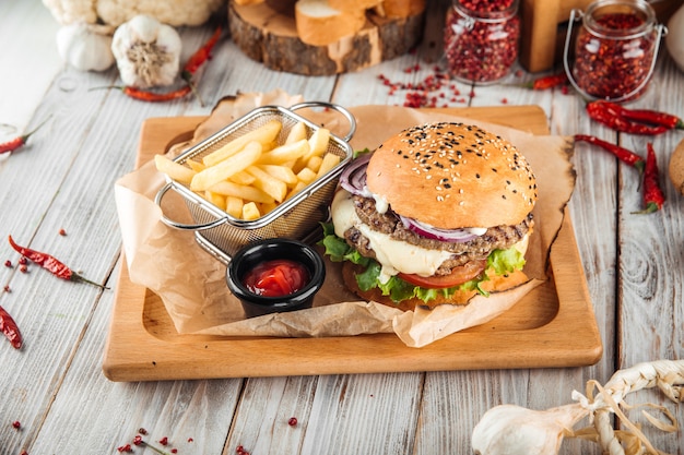 Delicious burger with lamb cutlet and vegetables