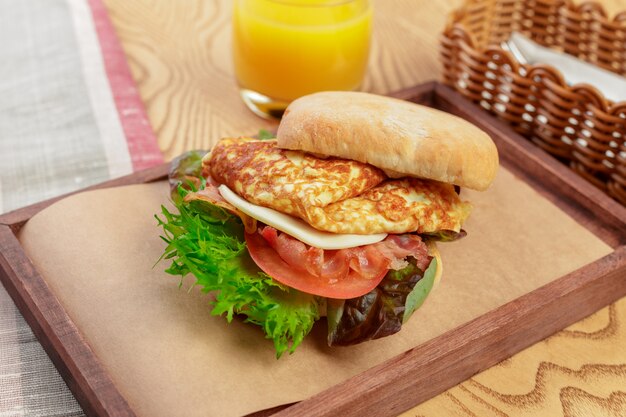 Delicious burger with omelette breakfast dish close up