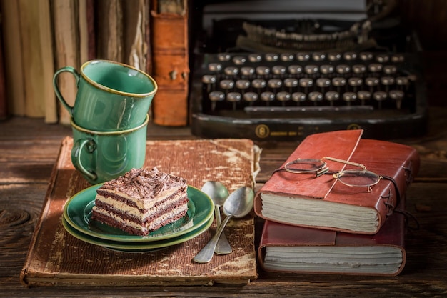 Delicious cake and coffee on desk writer