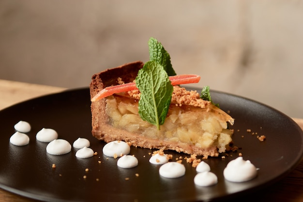 Delicious cake for desert in restaurant on a wooden table.