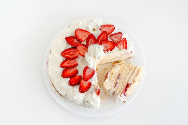 Delicious cake with cream cheese and strawberries Beautiful serving on a white brick background