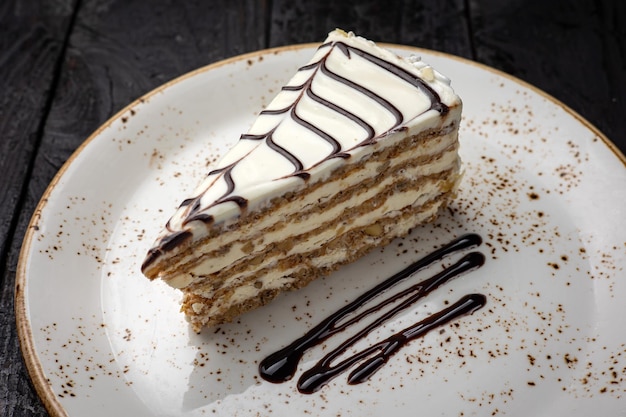 delicious cake with cream on a wooden background