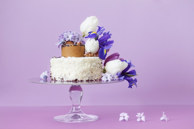 Delicious cake with Easter eggs and flowers