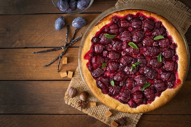 Delicious cake with fresh plums and raspberries