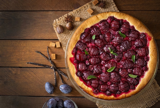 Delicious cake with fresh plums and raspberries