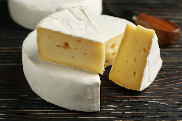 Delicious camembert cheese on wooden background, close up