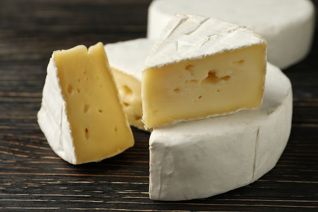 Delicious camembert cheese on wooden background, close up