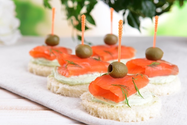 Delicious canapes on table closeup