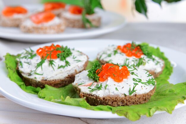 Delicious canapes on table closeup