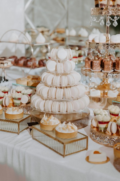 Delicious candy bar with cupcakes, macaroons and other sweets