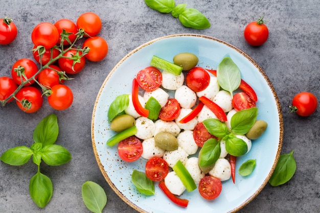 Delicious Caprese salad with ripe cherry tomatoes and mozzarella