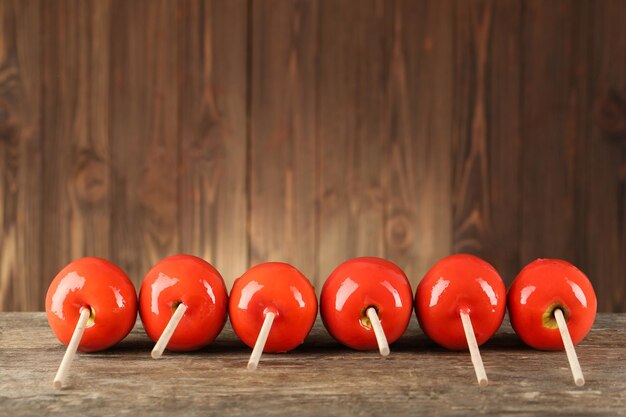 Delicious caramel apples on wooden background