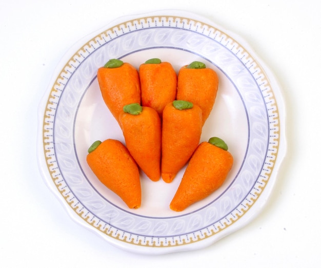 Delicious carrot shape Sweets of India on a plate