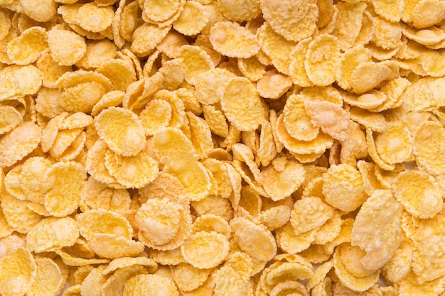 Delicious cereal cornflakes pile texture, closeup, top view