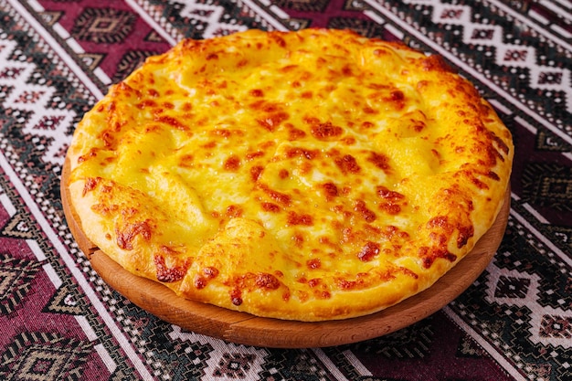 Delicious cheese pizza on traditional tablecloth