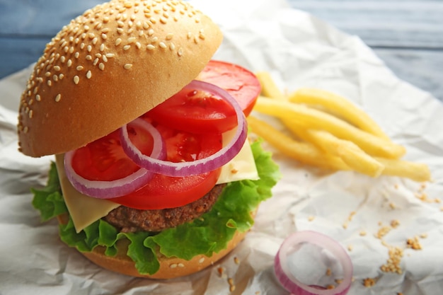 Delicious cheeseburger on paper background