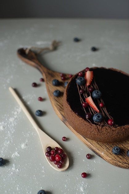 Delicious cheesecake decorated with berries on a wooden board